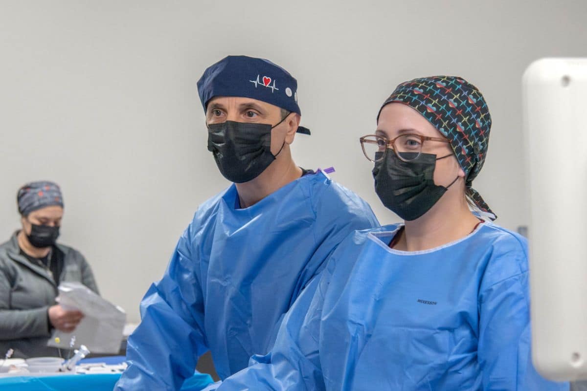 expert-cardioversion-monitoring-king-george-va Male and female doctors in blue scrubs monitoring patient during cardioversion at Oracle Heart and Vascular