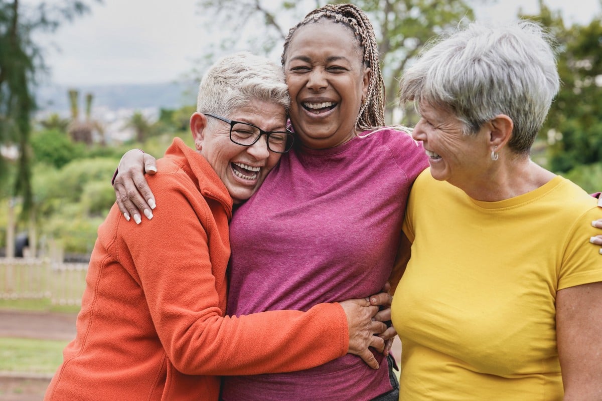 oracle-heart-and-vascular-womens-heart-conditions Three women laughing and embracing outdoors, representing women’s heart health and wellness at Oracle Heart & Vascular