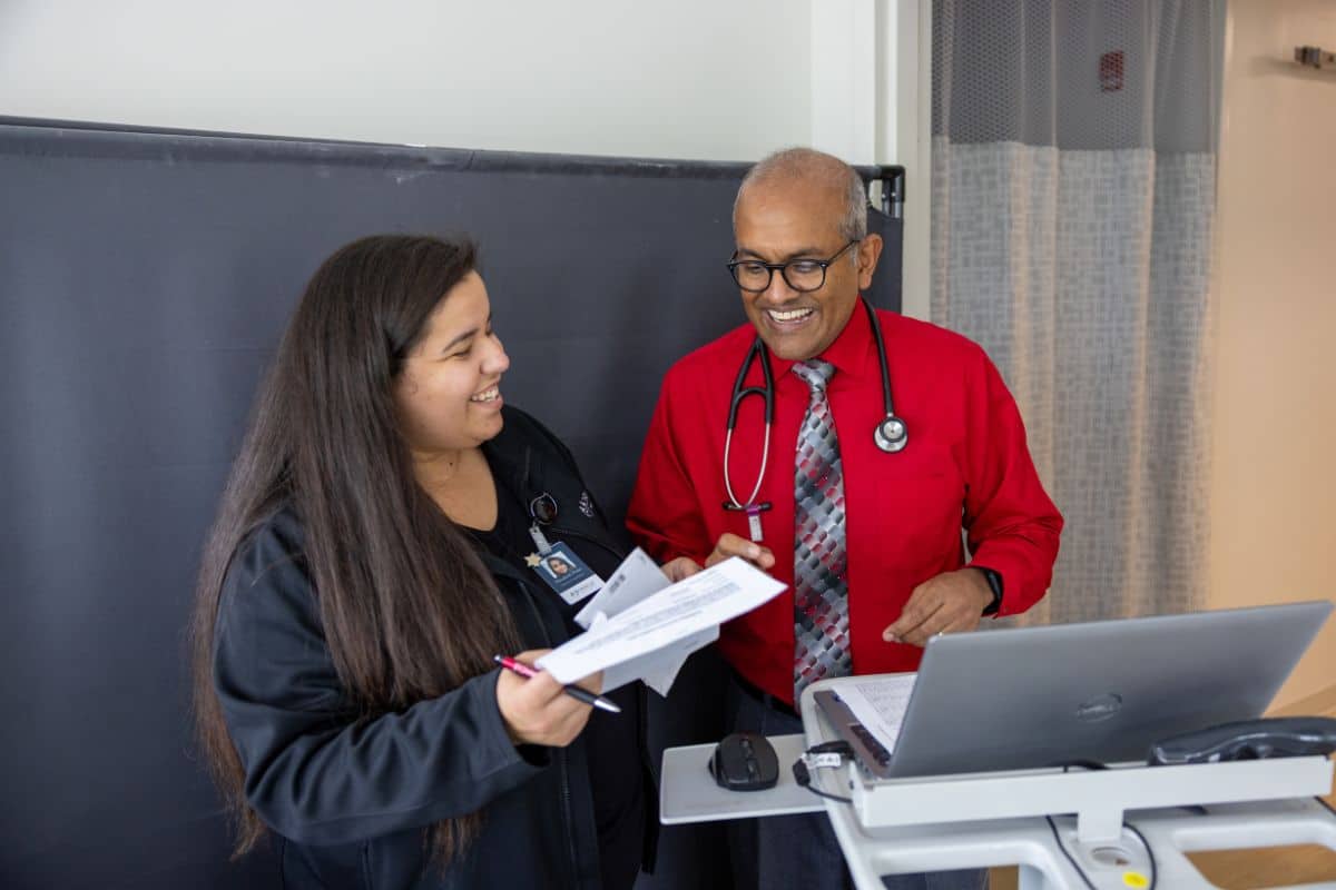 top-rated-ilr-implantation-king-george-fredericksburg-va Doctor discussing implantable loop recorder procedure with female colleague at Oracle Heart and Vascular in King George and Fredericksburg, VA