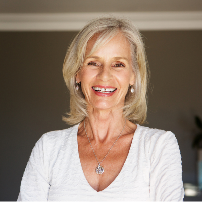 Older woman smiling and posing, representing benefits of regular heart diagnostic testing