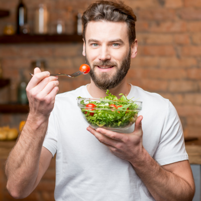 Man eating a salad, representing managing heart disease with diet