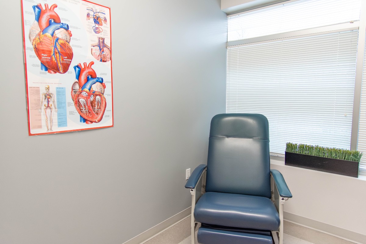 Oracle Heart & Vascular exam room with medical chair and heart anatomy chart in Fredericksburg, VA